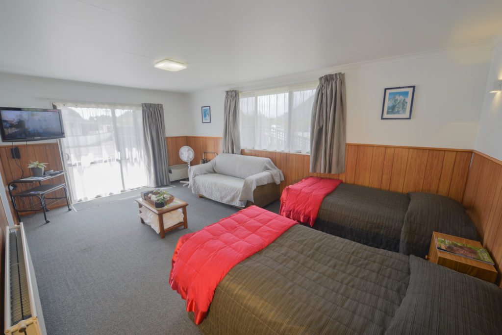 Double bed with sofa in motel room 5 wilderness haast new zealand